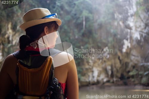 Image of Woman in hat among mountains