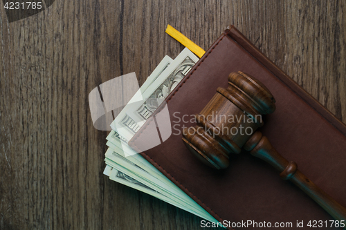 Image of Judge\'s hammer, folder with banknotes