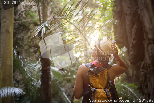 Image of Woman among thickets of palms