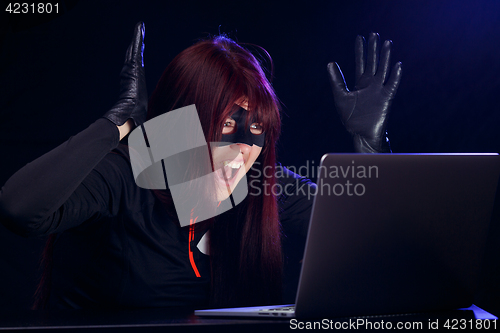 Image of Surprised night thief in laptop