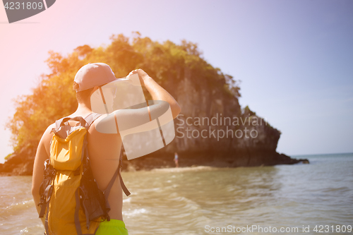 Image of Man with backpack on seacoast