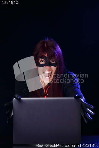 Image of Screaming brunette hacker at night