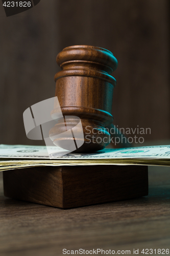 Image of Hammer on banknotes at table