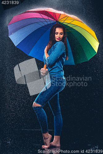 Image of Young beautiful woman with an umbrella.