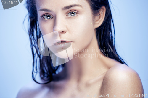 Image of Beautiful woman face portrait close up on blue