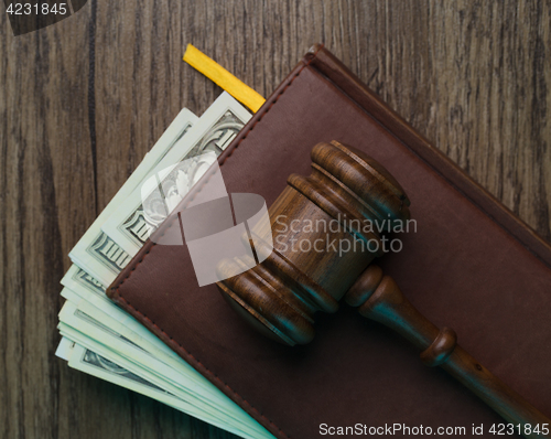 Image of Judge\'s hammer, folder with money