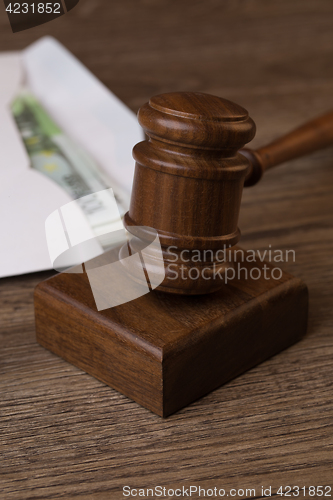 Image of Wooden table with hammer, money