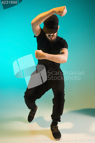 Image of The silhouette of one hip hop male break dancer dancing on colorful background