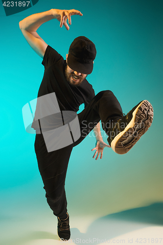 Image of The silhouette of one hip hop male break dancer dancing on colorful background