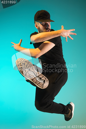 Image of The silhouette of one hip hop male break dancer dancing on colorful background