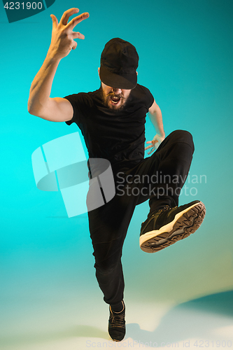 Image of The silhouette of one hip hop male break dancer dancing on colorful background