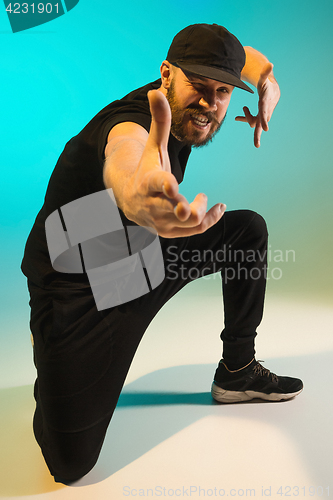 Image of The silhouette of one hip hop male break dancer dancing on colorful background