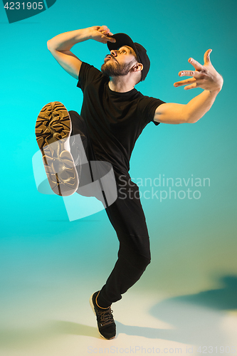 Image of The silhouette of one hip hop male break dancer dancing on colorful background