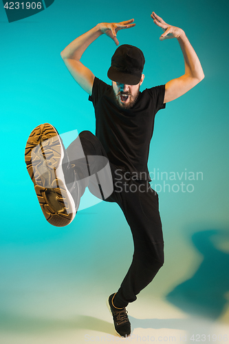 Image of The silhouette of one hip hop male break dancer dancing on colorful background