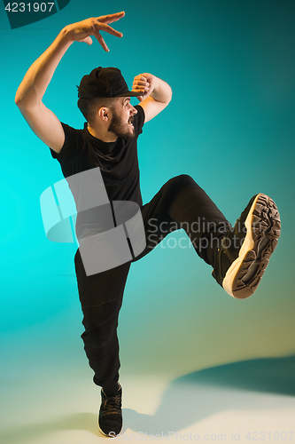 Image of The silhouette of one hip hop male break dancer dancing on colorful background