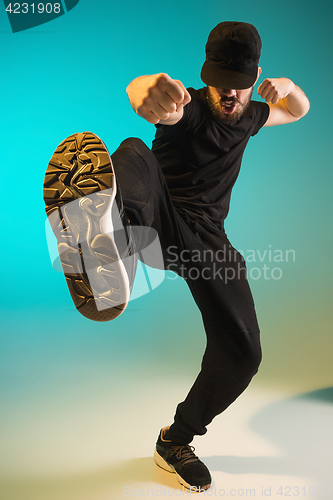 Image of The silhouette of one hip hop male break dancer dancing on colorful background