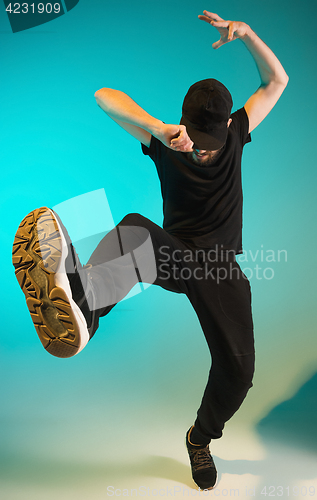 Image of The silhouette of one hip hop male break dancer dancing on colorful background