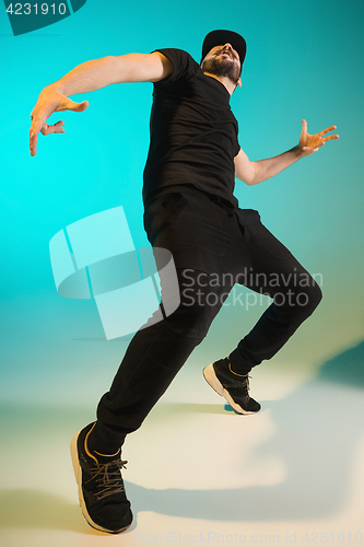 Image of The silhouette of one hip hop male break dancer dancing on colorful background