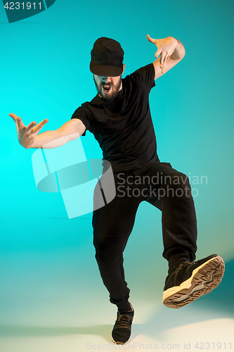 Image of The silhouette of one hip hop male break dancer dancing on colorful background