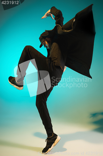 Image of The silhouette of one hip hop male break dancer dancing on colorful background