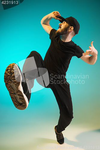 Image of The silhouette of one hip hop male break dancer dancing on colorful background