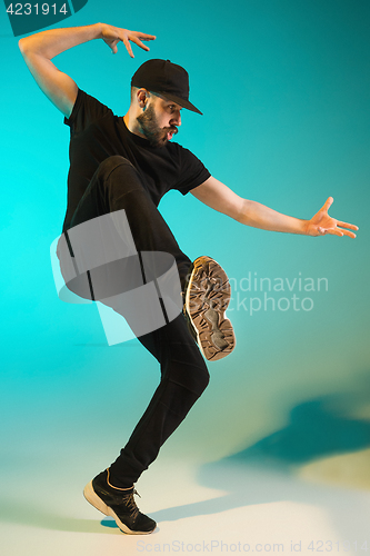 Image of The silhouette of one hip hop male break dancer dancing on colorful background