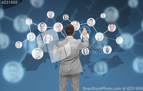 Image of businessman using virtual screen with contacts