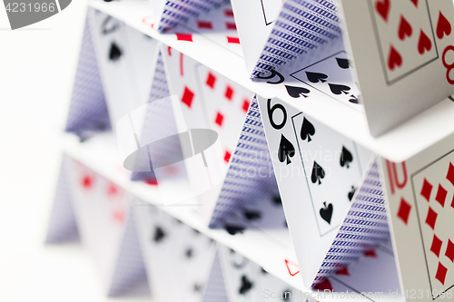 Image of house of playing cards over white background