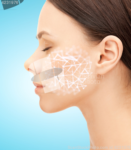 Image of woman face with low poly grid projection on cheek