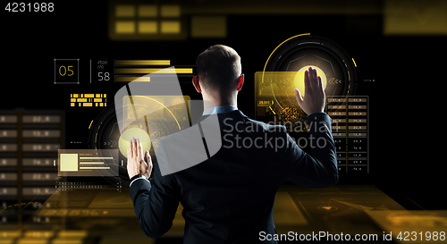 Image of businessman touching virtual screen