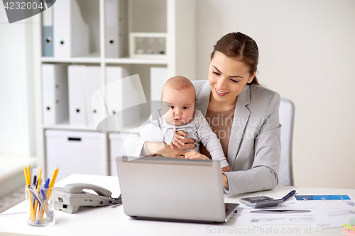 Image of happy businesswoman with baby and laptop at office