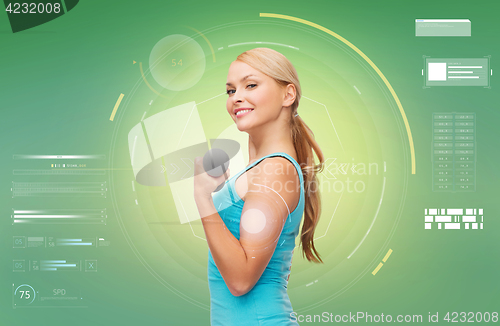 Image of happy sporty woman with dumbbell flexing biceps