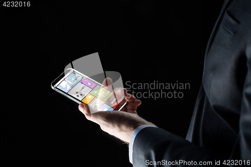 Image of close up of businessman with apps on smartphone