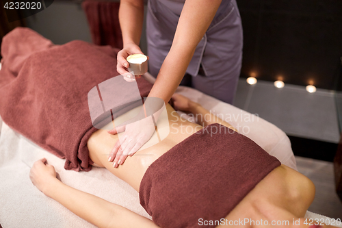 Image of woman lying and having massage with hot oil at spa