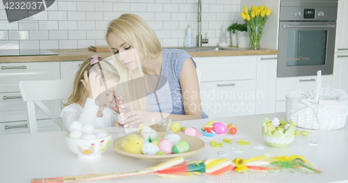 Image of Mother and daughter coloring eggs