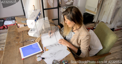 Image of Female tailor working with tablet