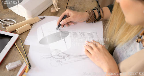 Image of Crop shot of dressmaker drawing sketches