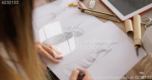 Image of Crop shot of dressmaker drawing sketches