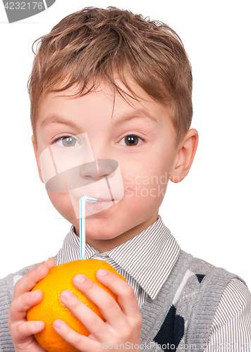 Image of Little boy drinking orange juice