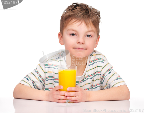 Image of Boy drinking refreshing orange juice