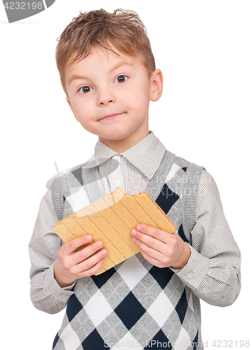 Image of Boy eating waffle isolated on white