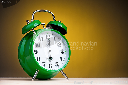 Image of Alarm clock on yellow background