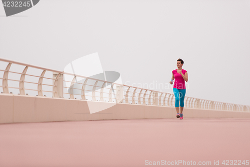 Image of woman busy running on the promenade