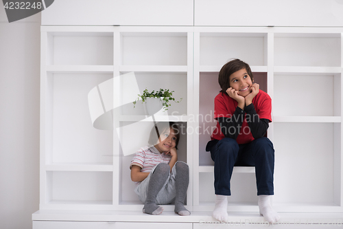 Image of young boys posing on a shelf