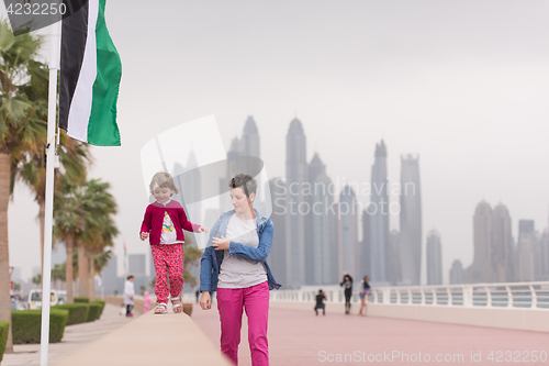 Image of mother and cute little girl on the promenade