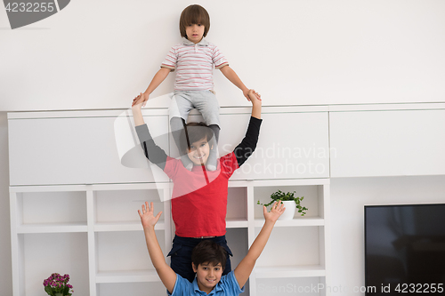 Image of young boys posing line up piggyback