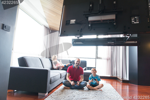 Image of Happy family playing a video game