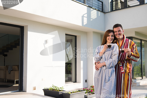 Image of Young beautiful couple in bathrobes