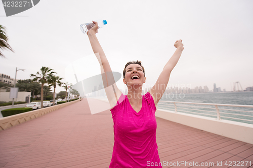 Image of young woman celebrating a successful training run