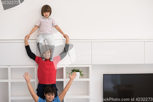 Image of young boys posing line up piggyback